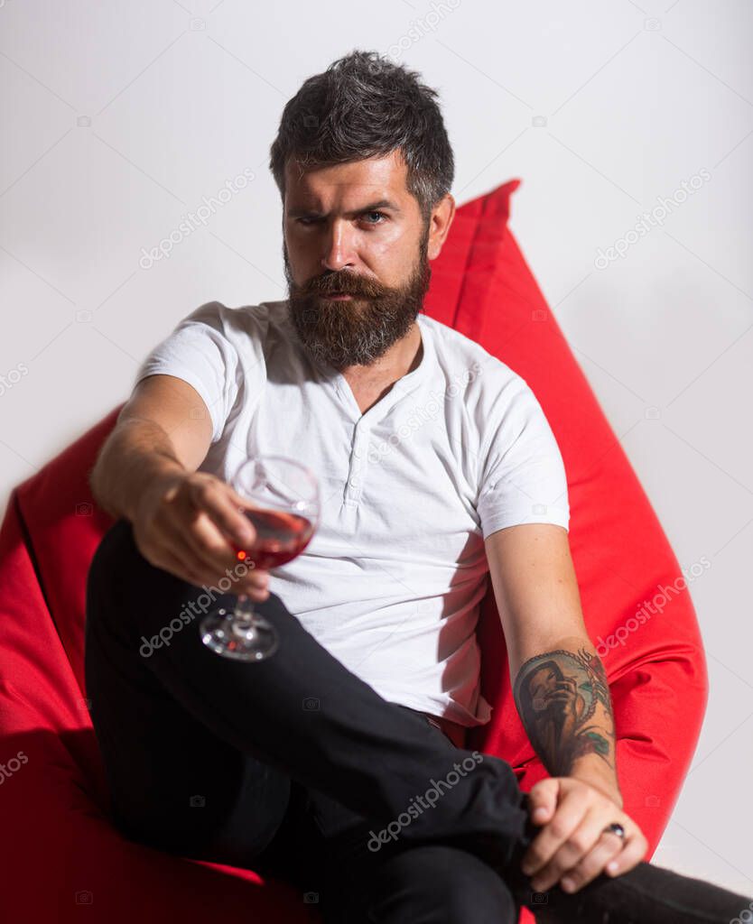 Bearded hipster drink glass of wine. Bad habits. Drinking alcohol. Home party.