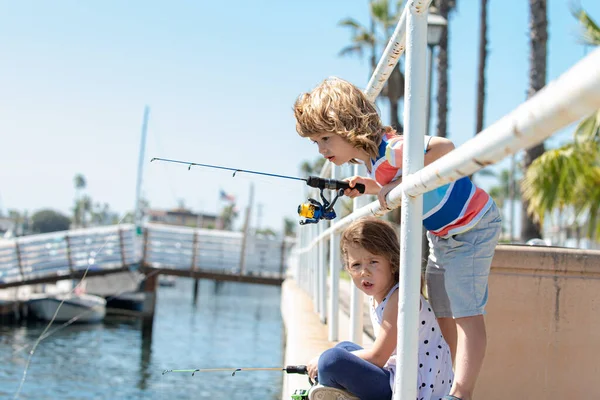 Kids hobby. Couple of kids fishing on pier. Child at jetty with rod. Boy and girl with fish-rod. — Stock Photo, Image