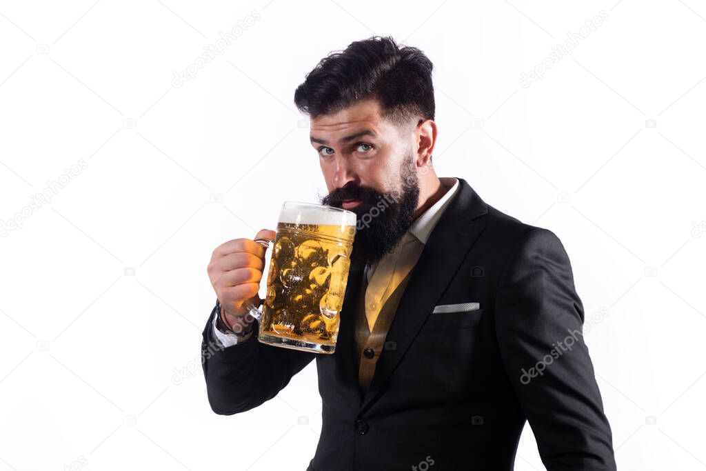 Portrait of handsome bearded man tasting a craft beer. Stylish handsome man in black suit drinking beer. Gay drinking lager beer.