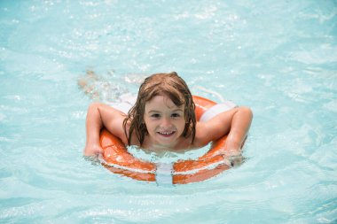 Yaz havuzunda bir çocuk. Çocuklar yaz tatili. Çocuk Aquapark 'ta eğleniyor. Mutlu çocuk can simidiyle oynuyor. Yaz çocuğu.