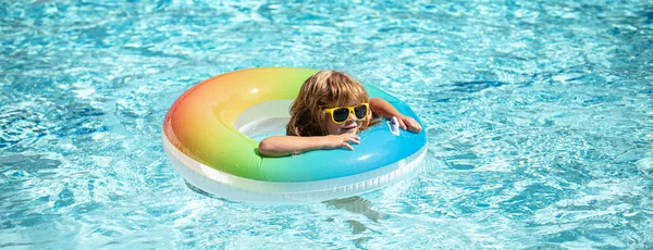 Yaz tatili. Yaz çocukları hafta sonu. Aquapark 'ta şişme lastik çemberde yüzen komik çocuk.. — Stok fotoğraf