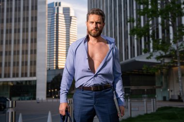 Beyaz takım elbiseli, beyaz gömlekli iş adamı ofisten çıkıyor. Son çalışma günü konsepti. Seksi moda işadamı.