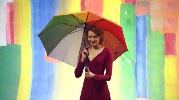 Tempo piovoso. Donna pioggia con ombrello arcobaleno. Autunno in vena. Sfondo astratto. — Video Stock