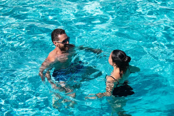 Couple in pool. Summer pool resort. Life winner. Butt in bikini. Pool party. — Stockfoto