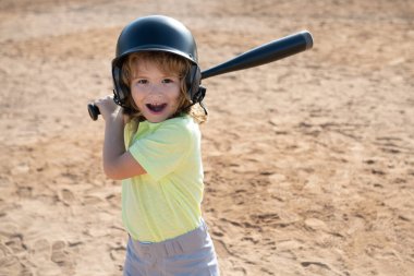 Portrait of excited amazed baseball player kid child wearing helmet and hold baseball bat. clipart