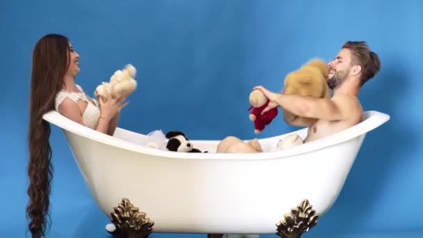 Couple relationship concept. Family life routine. Man and woman playing in bath. Happy couple. — Wideo stockowe