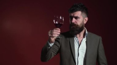 Sommelier tastes wine. Alcohol drink. Checking quality of red wine. Handsome bearded male drinking expensive red wine.