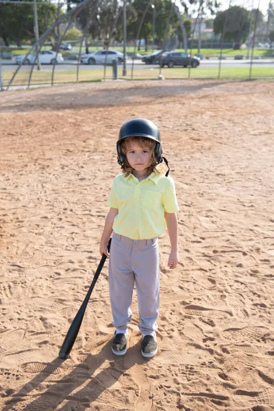 Funny kid baseball player in baseball helmet and baseball bat