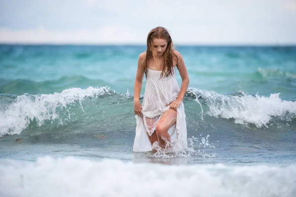 Junge sexy Frau auf Wellen Meer. Sommer Strand sinnliche Mädchen. Mädchen im weißen Kleid im Urlaub am tropischen Strand. — Stockfoto
