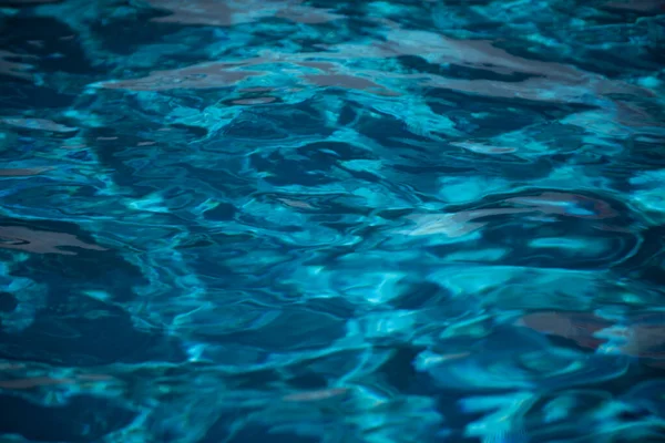 抽象的なリップル波とスイミングプール内の明確なターコイズブルーの水面、背景と抽象的なデザインのための青い波. — ストック写真