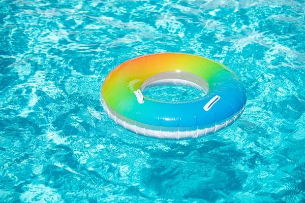 Akva strukturovaná. Bazén float, kroužek plovoucí v osvěžujícím modrém bazénu na letním pozadí. — Stock fotografie