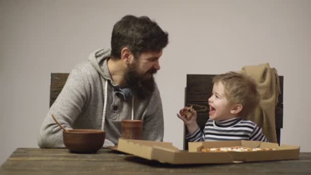 Pizzeria. Dad and kid eating pizza. Italian cuisine. Happy childhood. Fast food for dinner lunch. — Stok video