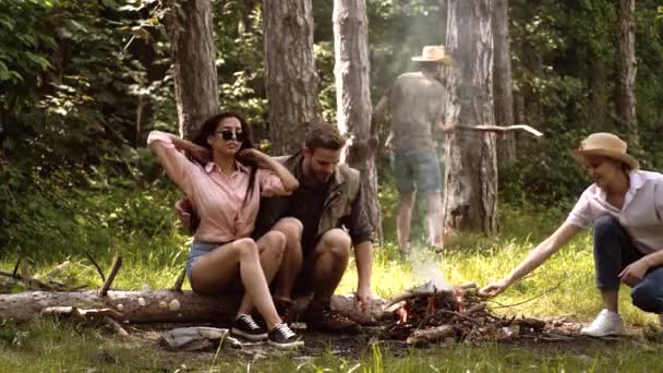 Summer lifestyle. Company have picnic at forest. Nature background. Friends at bonfire and having fun at camp fire. — Vídeo de stock