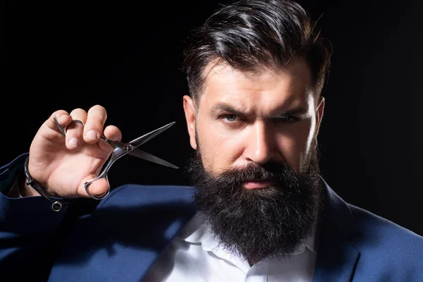 Closeup bearded man, portrait of man with long beard and moustache. Barber scissors for barber shop. Vintage barbershop, shaving. Brutal serious male with modern hairstyle on black. — Stock Photo, Image