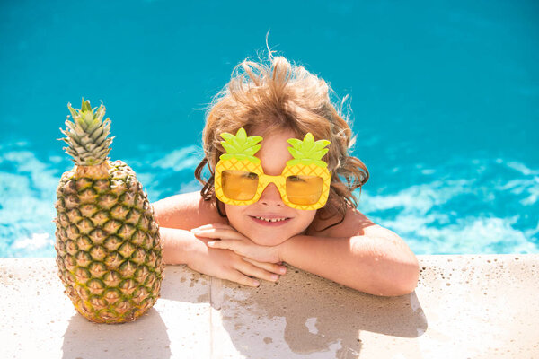 Happy child in the swimming pool. Funny kid boy playing outdoors. Summer vacation concept.