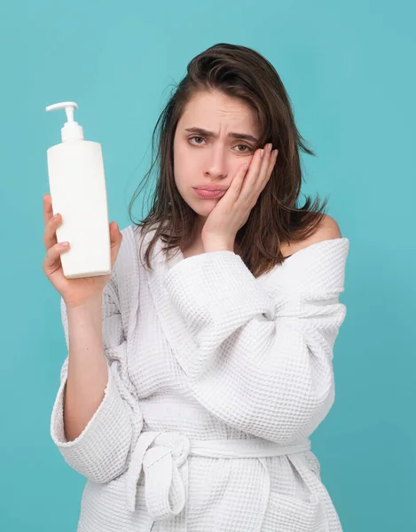Женщина с проблемой выпадения волос держать бутылку шампуня и кондиционер. — стоковое фото