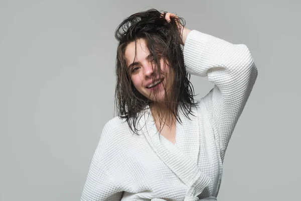 Menina tocando seu cabelo depois de tomar banho. Saúde cabelo e conceito de beleza. Uma menina bonita no estúdio com cabelo molhado. Beleza cosméticos cuidados com o cabelo. — Fotografia de Stock