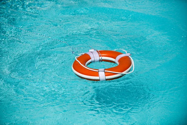 Lifebuoy on the water background. The concept of help, rescue, drowning.