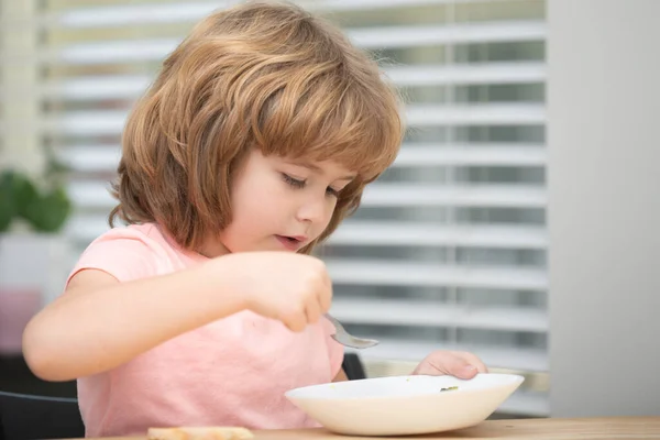 Funny kid with plate of soup. Child dinner. — Stock Photo, Image