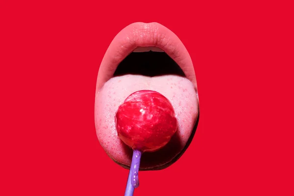 Sexy woman mouth with pink lips holding lollipop, beauty closeup. Sexy girl suck lick lollipop. Beauty glamour concept, close-up isolated on red. — Zdjęcie stockowe