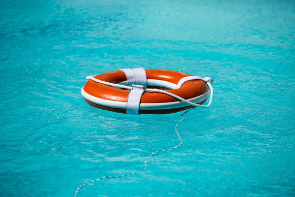 Help and drowning concept. Life saver ring floating in the water.