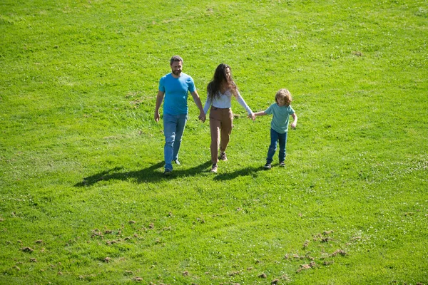 Happy young parents playing with child outside in park. — Stock Photo, Image