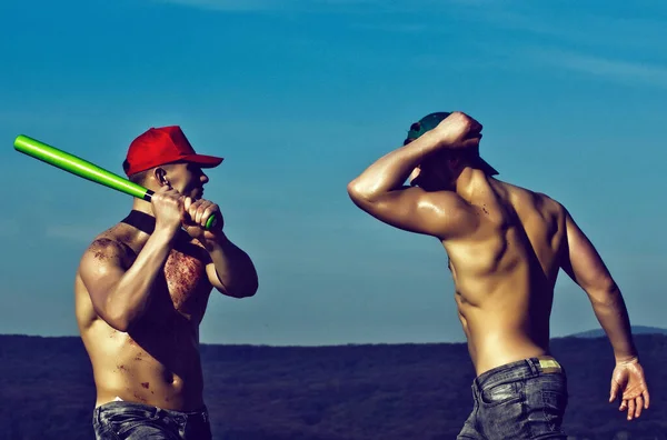 青い空に野球バットで戦う筋肉の男たち — ストック写真
