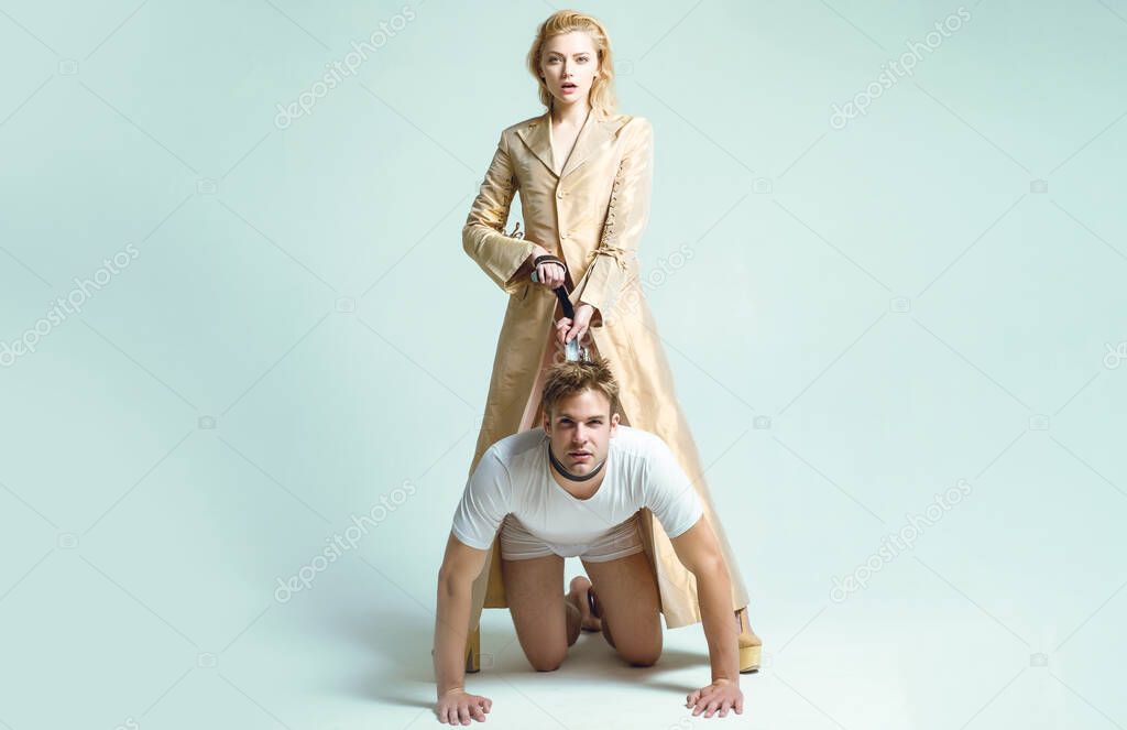 Dominantning in the foreplay sexual game. Woman and man playing domination games. Love relations and dominating. Concept of sexual domination and bondage. Dominant womans.