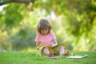 Children learning in park. Cute pupil in elementary school.