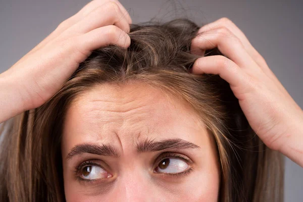 Sad woman looking at damaged hair, the hair loss problem. Studio isolated portrait, copy space. — Stock Photo, Image