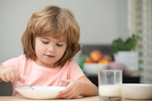 Funny kid with plate of soup. Child dinner. Preschool child kid enjoying breakfast in morning, holding spoon. — Stock Photo, Image