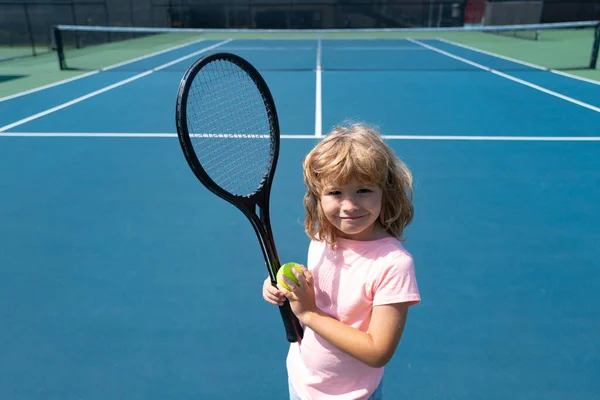 Un tenista divertido en una cancha de tenis. Niño con raqueta de tenis y pelotas de tenis. —  Fotos de Stock