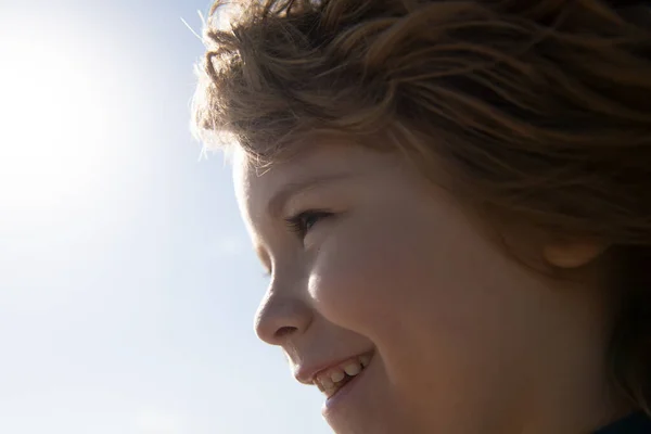 Retrato de un niño rubio pequeño, primer plano. Linda cara de perfil de niños felices. Un niño emocional positivo. Sonriente boca de niños. —  Fotos de Stock