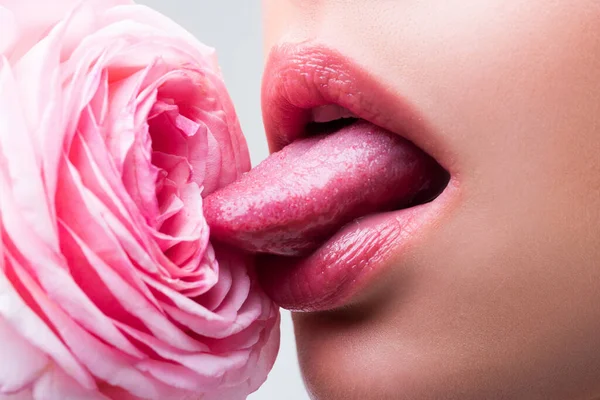 Lips with lipstick closeup. Beautiful woman lips with rose. Girl blowjob with tongue, symbol. — Stockfoto