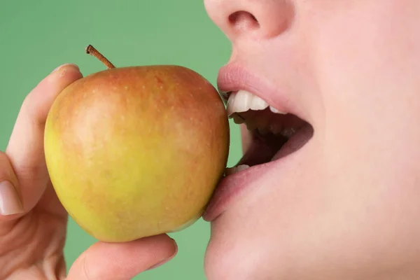 歯のケア。健康的な白い歯はリンゴで閉じます. — ストック写真