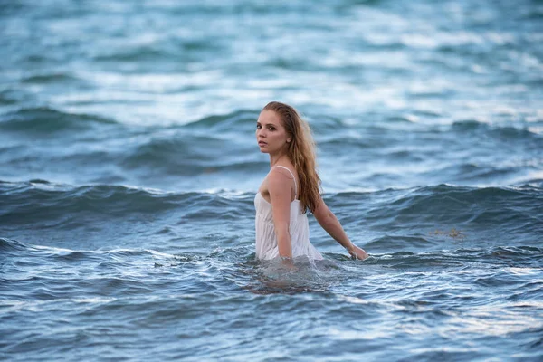 Fiatal szexi nő úszik az átlátszó, kék tengerben. Érzéki karcsú nő lebeg az óceán vizén. Nedves szexi ruha. — Stock Fotó