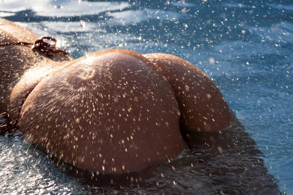 Sensual ass in swimming pool close up, summer journey, woman with hot natural butt relax in water. Wet body, backside in sexy bikini. Seduction and pleasure model. Luxury passion buttocks. — Stock Fotó