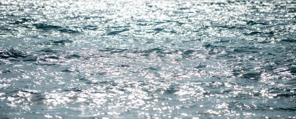 Sfondo marino estivo. Texture della superficie dell'acqua. Splendente modello ondulazione acqua blu. — Foto Stock