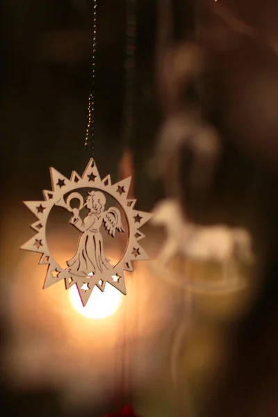 Wooden angel hanging against toys inside the star — Stock Photo, Image