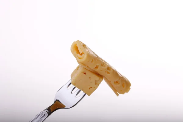 Pedaço de queijo em garfo — Fotografia de Stock
