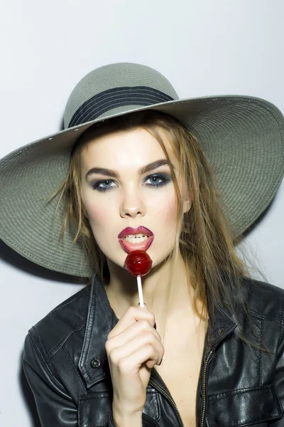 Young sexy girl in a hat with lollipop — Stock Photo, Image