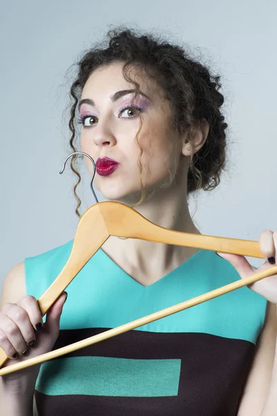 Woman holding hanger — Stock Photo, Image