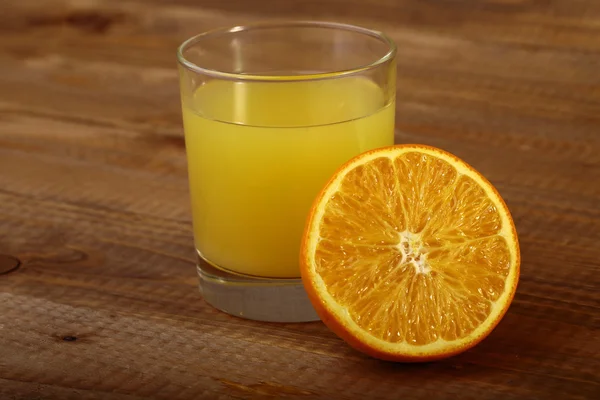 Orange fruit and glass of juice — Stock Photo, Image