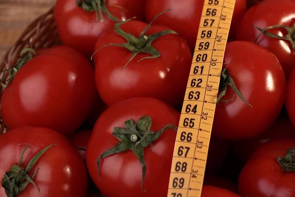 Ripe tomatoes and measuring tape — Stock Photo, Image