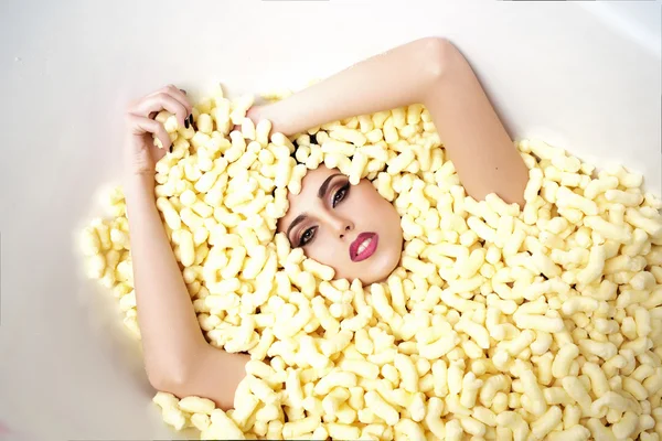 Fashionable woman in corn sticks heap — Stock Photo, Image