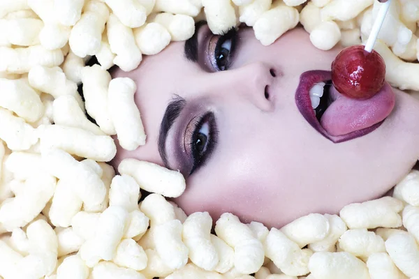 Fashionable woman in corn sticks heap — Stock Photo, Image