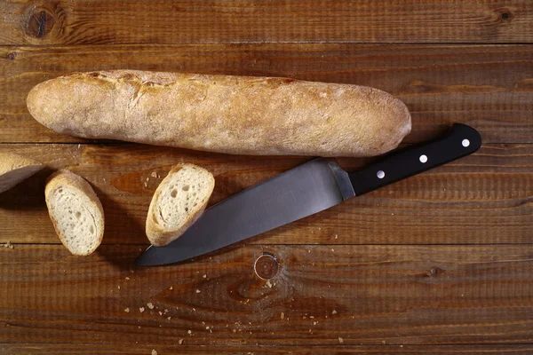Sliced up baguette and knife — Stock Photo, Image