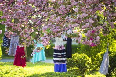 Child's dresses on the tree clipart