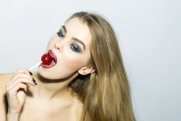 Captivating young blonde girl portrait with sugar candy — Stock Photo, Image