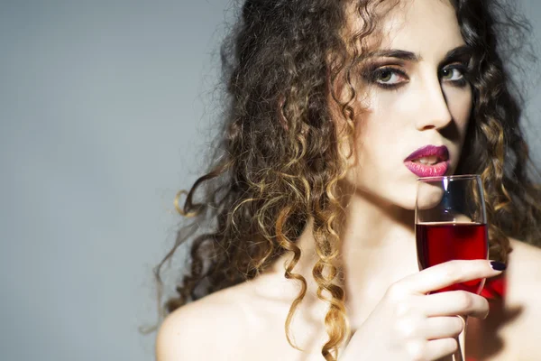 Attractive young woman with glass of red wine — Stock Photo, Image